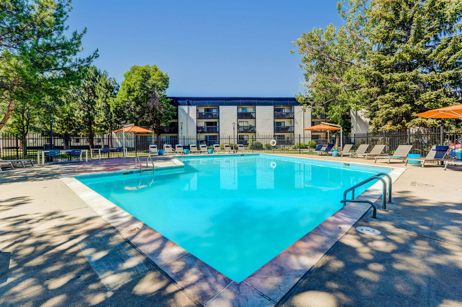 pool view with loungers and view of building