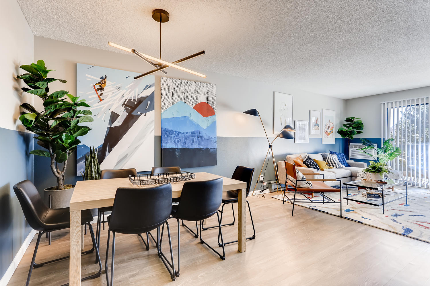 Living room and dining area with decor and large patio window